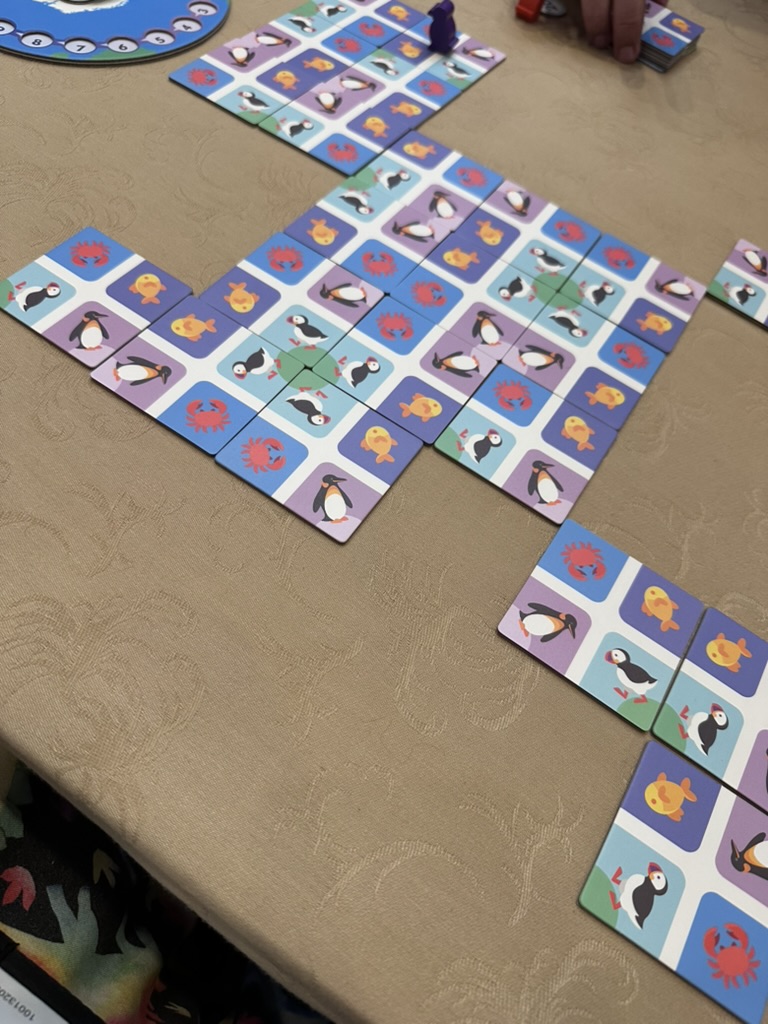 Poles Apart board game with tiles with puffins, penguins, crab, and fish